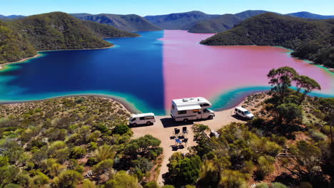 stunning split-color lake with campervans in a mountainous landscape