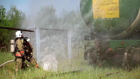 firefighters fighting a fire at a tanker truck