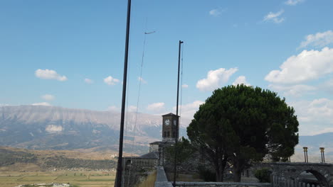 gjirokastra castle, taking over the albanian flag and later framing the famous clock tower inside the castle