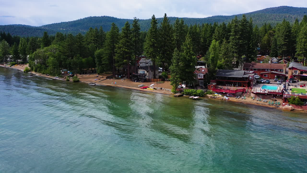 Aerial view of resorts and a beach on the coast of Lake Tahoe, in sunny USA