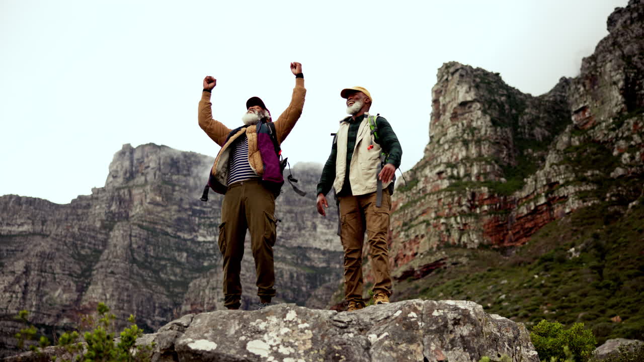 Elderly Hikers Celebrate Reaching Mountain Peak