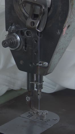 women's hands behind her sewing machine