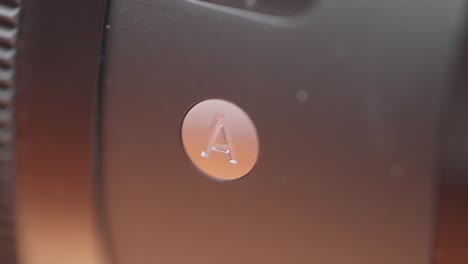 close-up of a camera lens button with the letter a