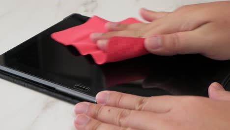 cleaning tablet screen with a microfiber cloth for anti-bacteria virus and disinfecting