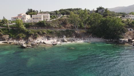 Aerial-view-of-Kassiopi-fishing-village-coastline,-Corfu,-Greece