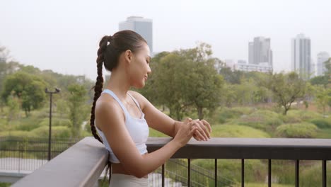 young fitness woman in sportswear using smart watch while exercising in city park, healthy and lifestyles.