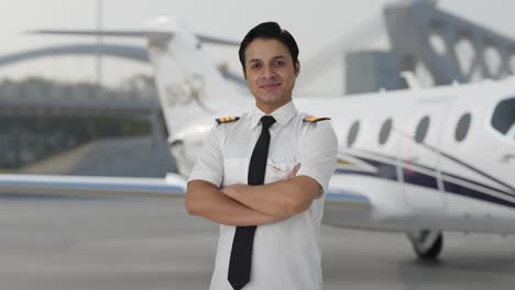 Portrait-of-Happy-Indian-pilot-standing-crossed-hands