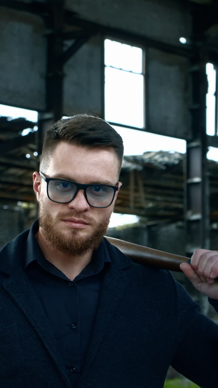 Aggressive man with baseball bat. Muscular man with baseball bat on the ruins