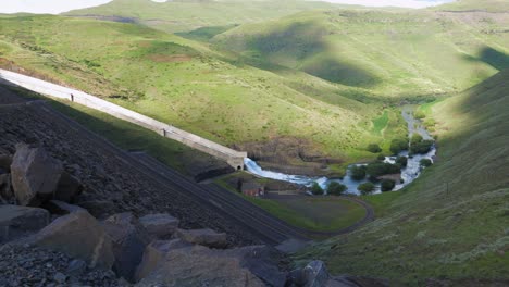 flood water from hydro electric dam flows down spillway into river