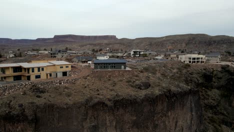 houses on the edge of a cliff then ascending to reveal the southern utah town of la verkin