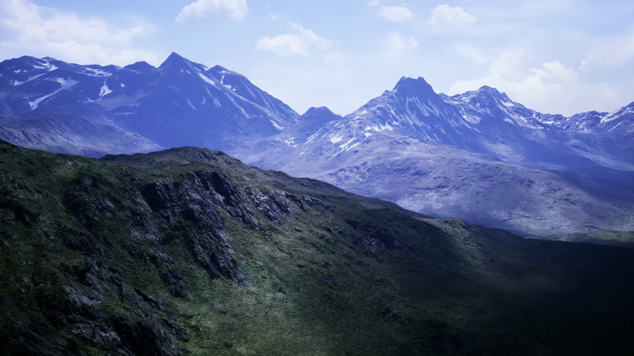 Majestic mountain range under a bright sky at dawn