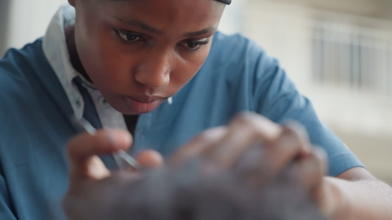Closeup black woodworker carving wood, intense hands shaping timber with chisel, focused expression, denim shirt, headwrap, workshop background, stepwise restoration, finishing touches, cinematic