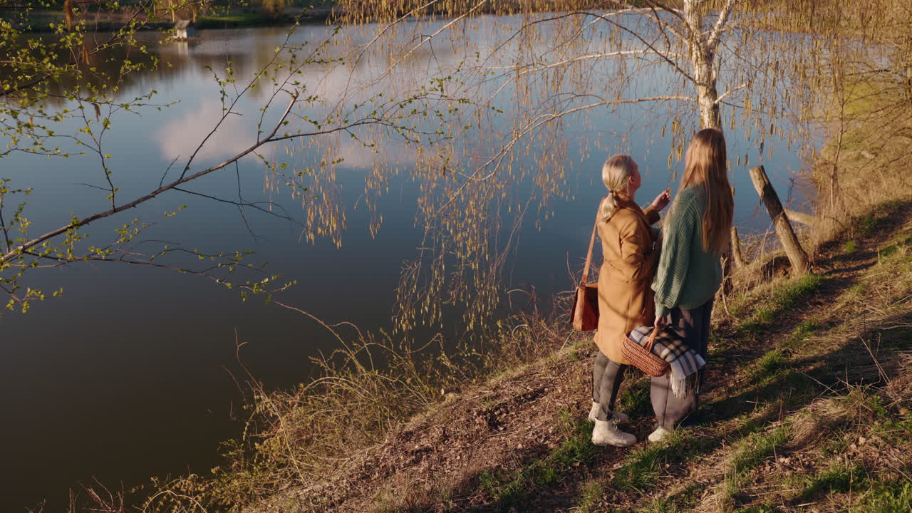 Two women enjoying a picnic by the lake