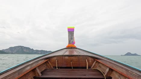 boat travels through ocean towards distant islands