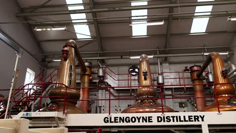 copper stills and equipment inside distillery