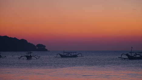 Traditional-Balinese-Fishing-Boat-Jukung-Off-Jimbaran-Beach-During-Sunset-In-Bali,-Indonesia