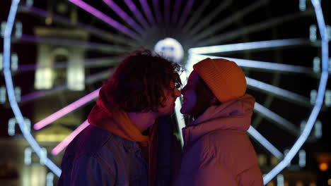 Cheerful-couple-touching-noses-on-street.-Man-and-woman-having-fun-in-city.