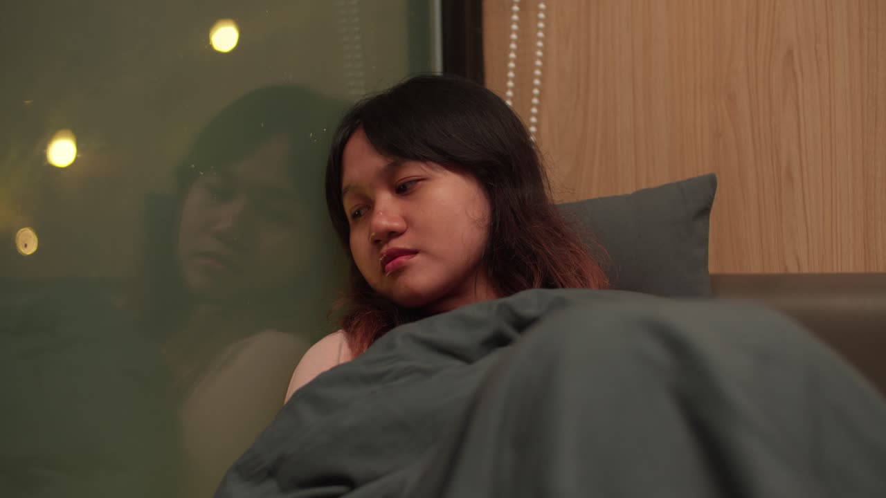 Young girl dozing, comfortable safe home, window reflections, close-up