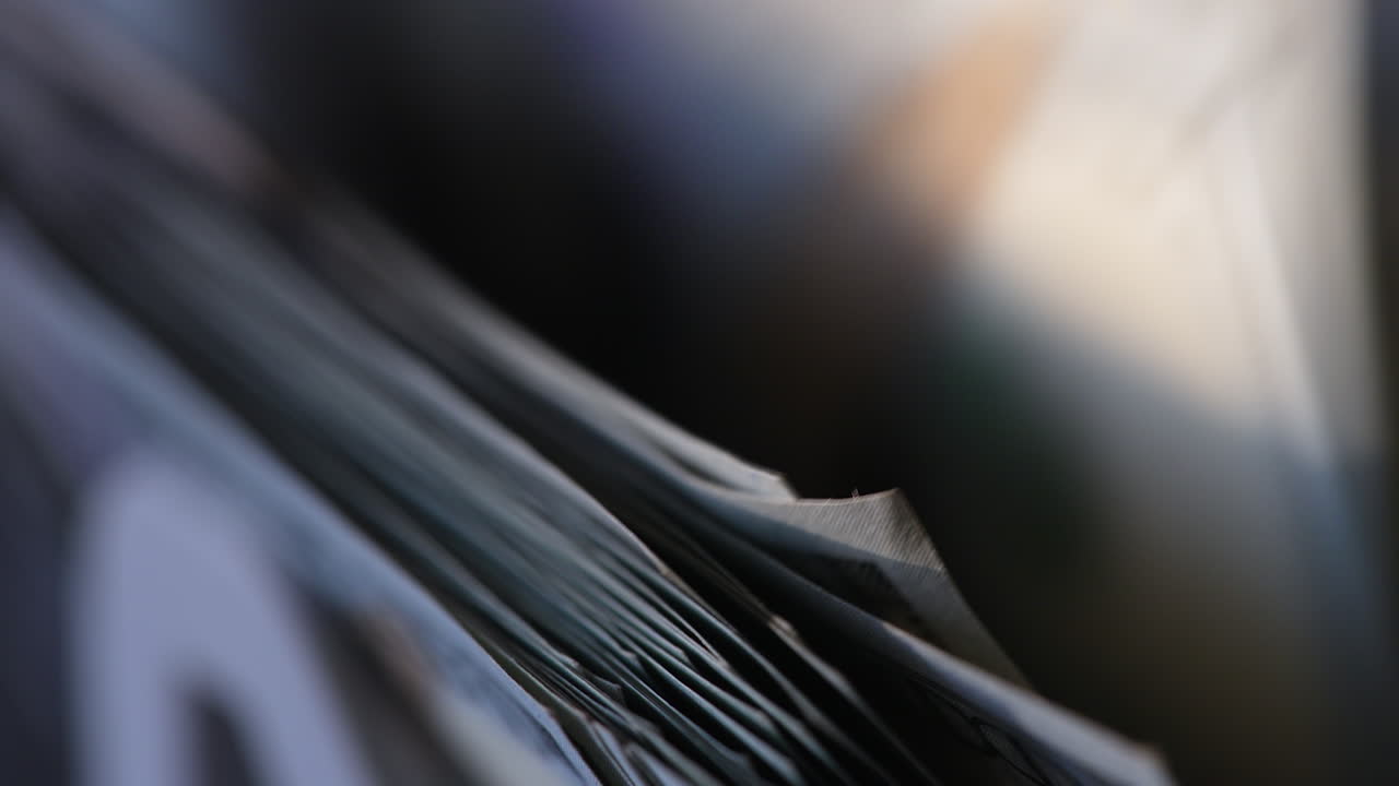 American one hundred dollar bills are counted in the machine. Macro footage of banknotes moving in equipment. Close up.