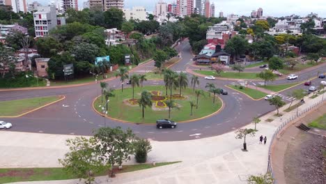 Cars-driving-through-scenic-road-with-the-view-of-skylines-at-background,-border-station-of-Argentina-and-Paraguay-at-Posadas