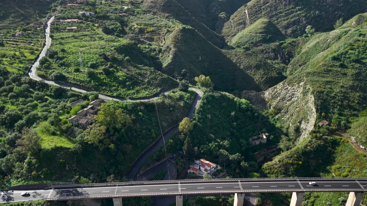 Aerial view of highway bridge in green hills, Taormina, Sicily