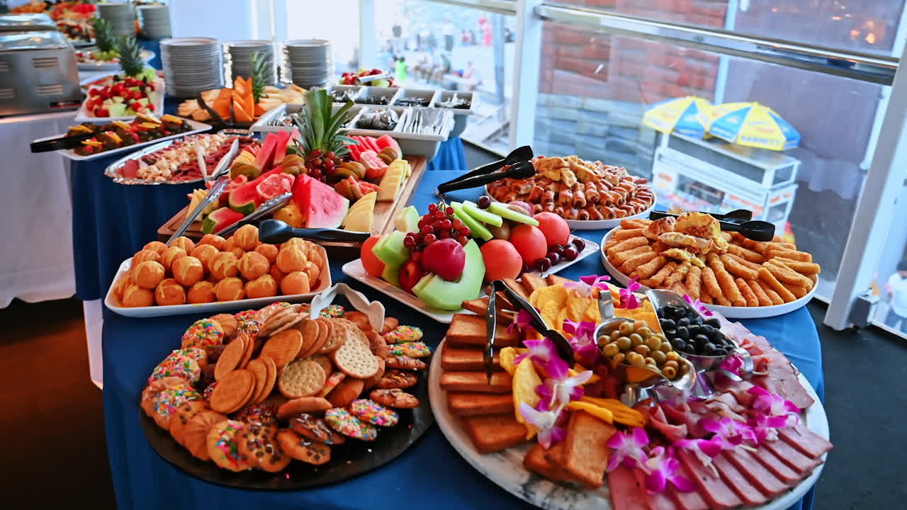 Luxury cruise ship buffet with fruits, snacks, and desserts. Colorful banquet buffet table on cruise ship with fruit platters, pastries, snacks, and appetizers