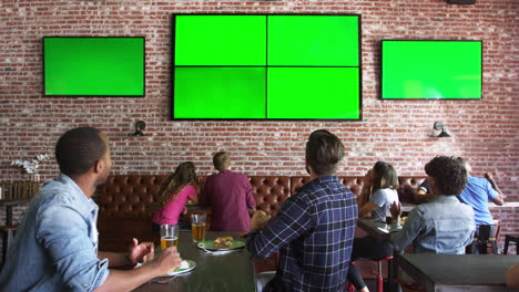 friends watching game in sports bar on screens shot on r3d
