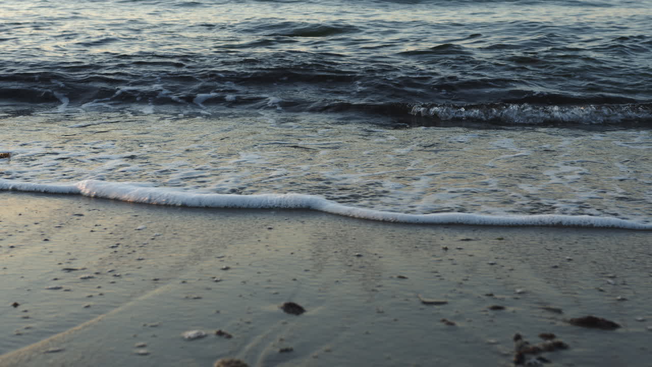 Small waves reach the beach, 4k