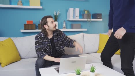 Happy-young-male-friends-meeting-and-chatting-at-home.