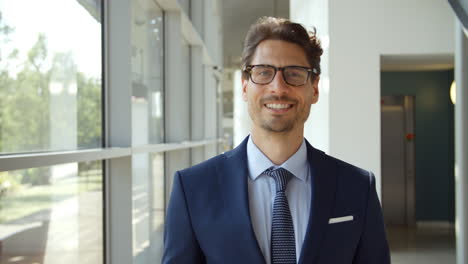 Portrait-Of-Businessman-Walking-Towards-Camera-And-Smiling