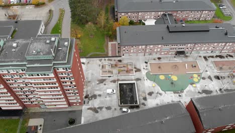 car driving around modern apartment buildings at daytime