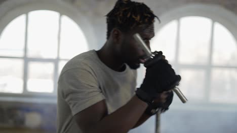 Boxer-Practicing-Shadow-Boxing-In-Foggy-Sport-Studio-With-Weights