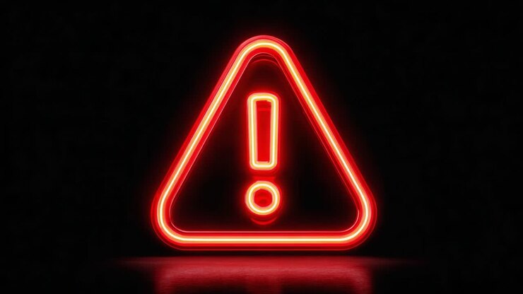 Segnale di avvertimento illuminato al neon rosso: una rappresentazione visiva sorprendente di cautela e attenzione in un ambiente buio