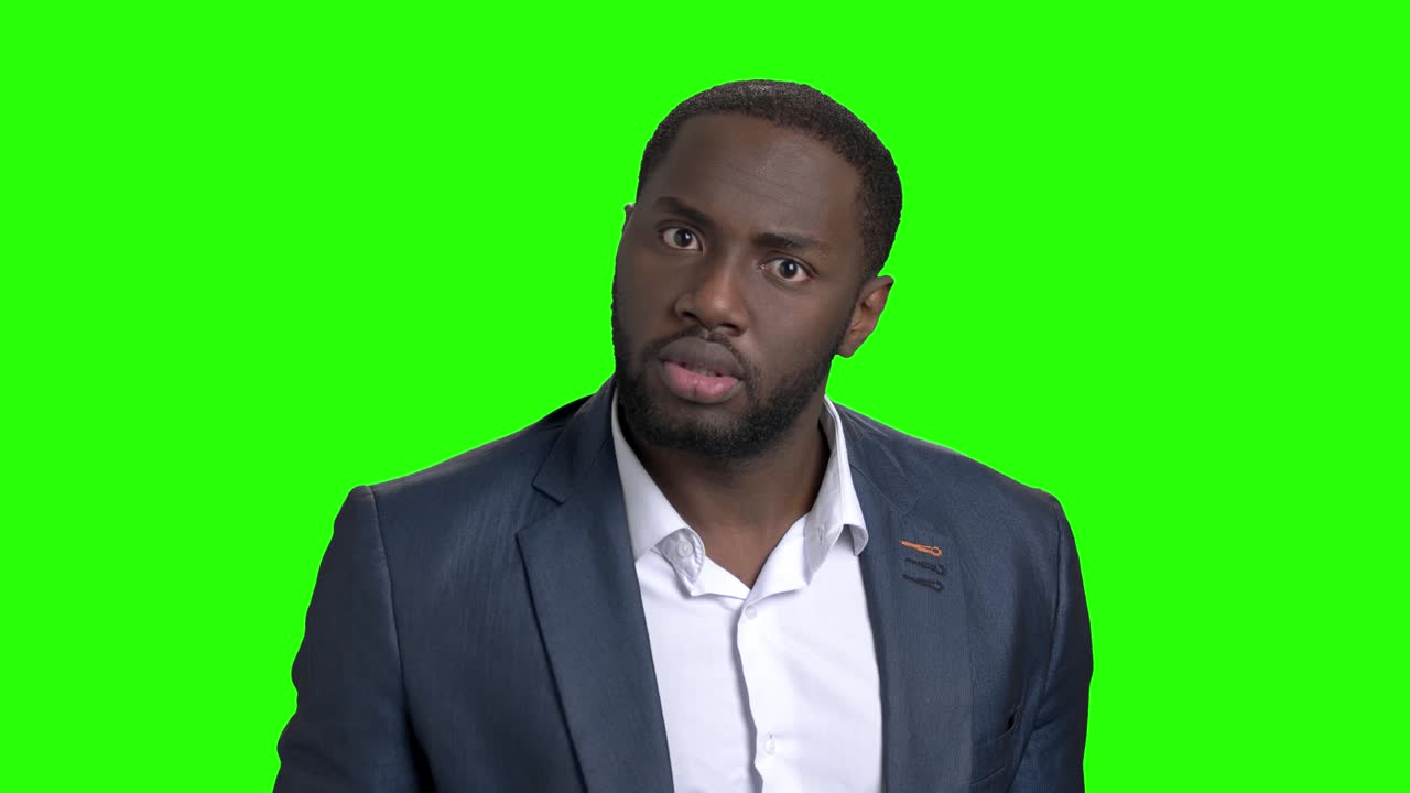 Afro-american businessman showing silence gesture.