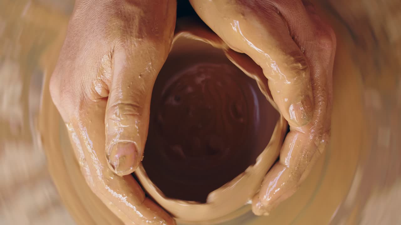 Pottery Workshop: Hands Shaping Clay on a Pottery Wheel