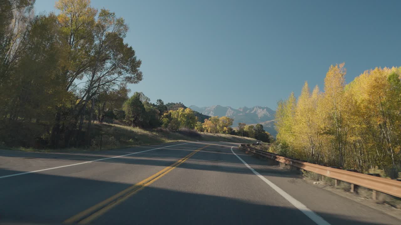 Scenic Road Through Mountains and Autumn Trees