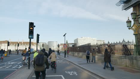 cyclists and electric scooters crossing a junction on the traffic light, london.