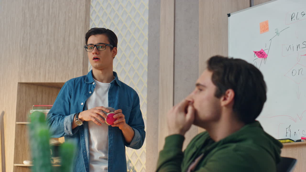 편안한 프리랜서들이 공을 던지고 사무실에서 가까이 얘기합니다. 파트너들이 토론합니다.