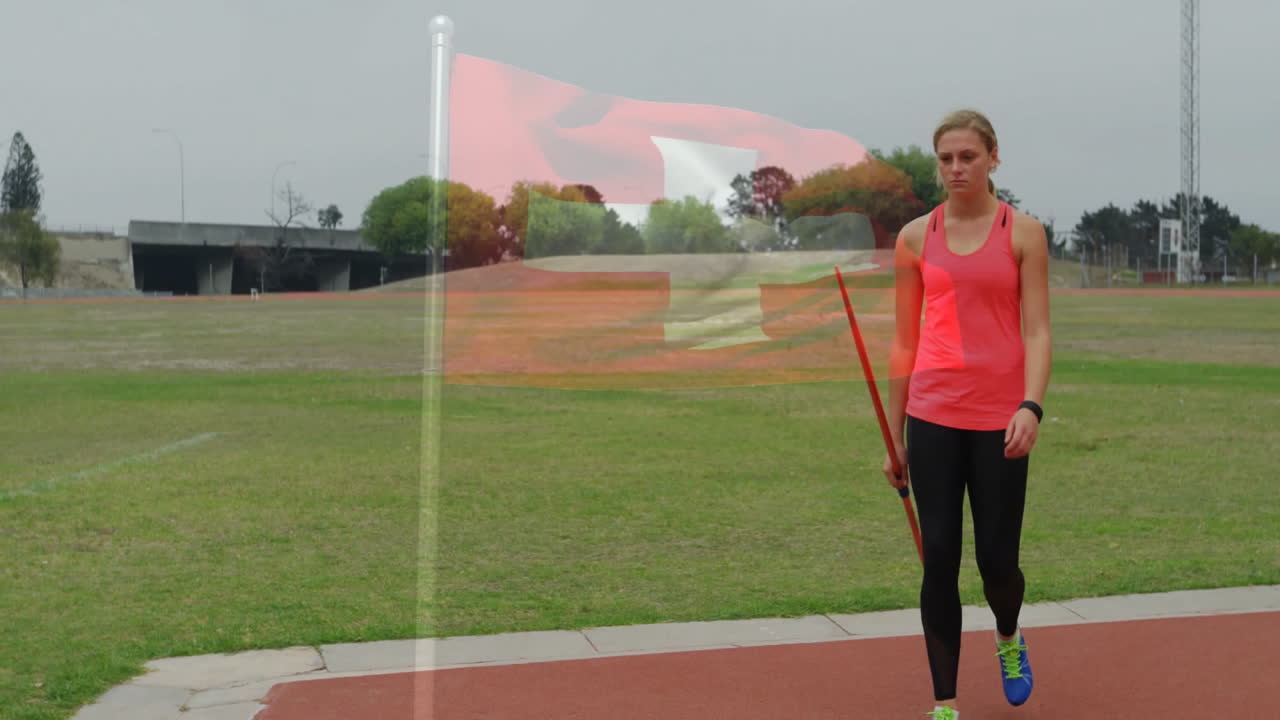 Athlete holding javelin walking on track with flag animation overlay