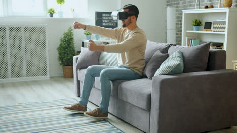 man playing virtual reality game on a couch