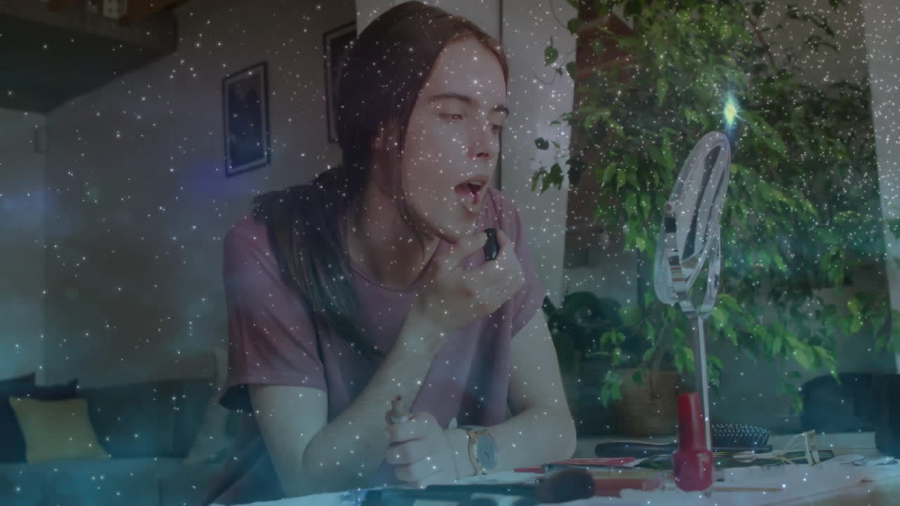 Young person applying makeup at home with sparkling animation overlay