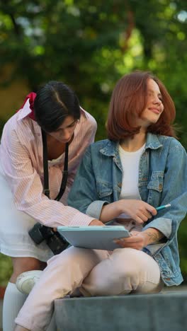 two women collaborating outdoors