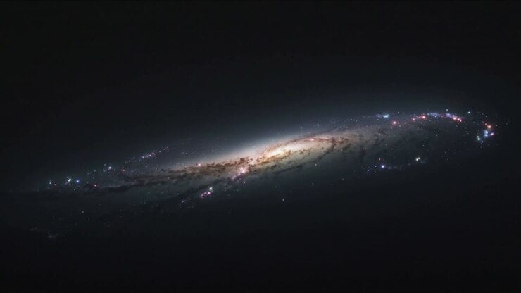Recording frames showing edge-on spiral galaxy bulge brightening in deep space, knots fluctuating