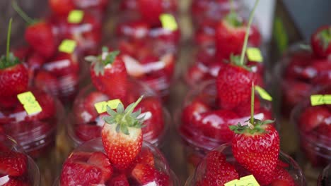 strawberries in cups at a market