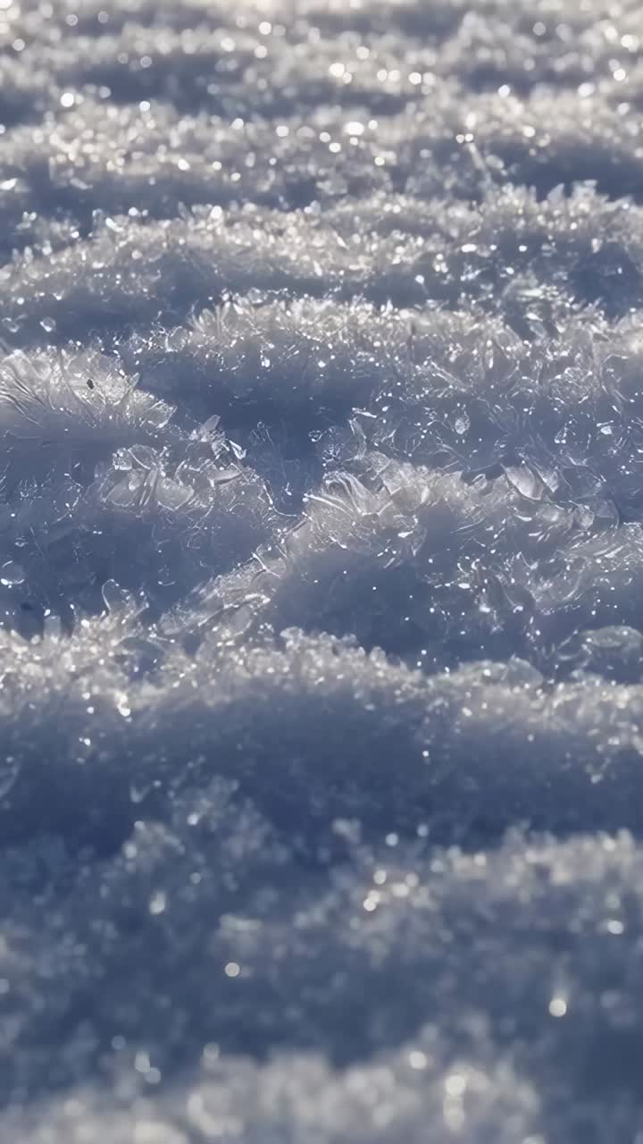 Video verticale: messa a fuoco della fotocamera che si sposta su creste di ghiaccio sulla neve, rivelando cristalli di ghiaccio scintillanti