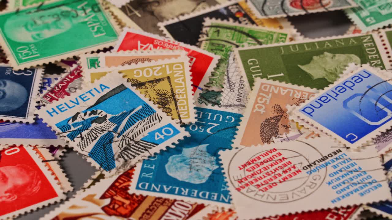 Stamps from different countries and eras mixed on a flat surface