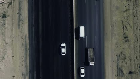 a slow mo aerial top view of traffic moving on a highway in northern areas