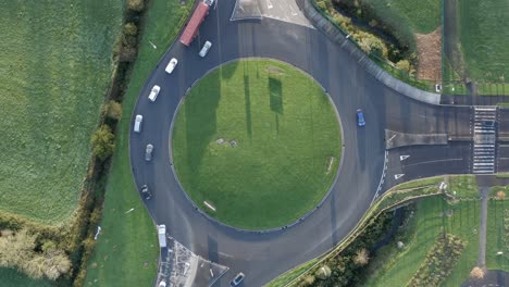 Bird's-eye-view:-Automobiles-driving-in-circles-on-highway-roundabout