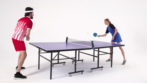 playing table tennis, man and woman competing in intense match indoors