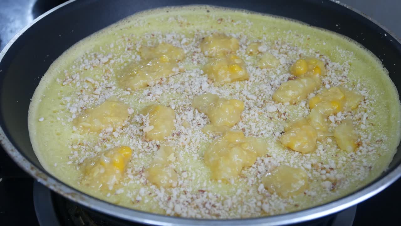 Apam balik or Malaysian Peanut Pancake turnover.  Flour pancake stuffed with sugar and corn topping. Cooked using the hot pan. Famous street food in Malaysia